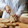 Chef cutting bread in his atelier